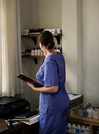 A doctor checking medicine stock