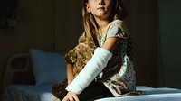 Young Caucasian girl with broken arm in plaster cast