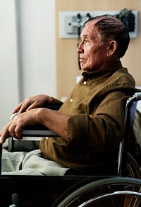 An elderly man sitting on a wheelchair