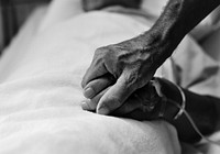 Old person holding hands of an elderly patient