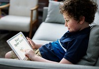 Young Caucasian boy using digital tablet
