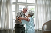 Happy senior couple dancing in the hospital