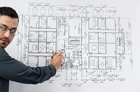 Businessman and blueprint of a building