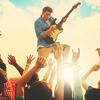 Young Man with a Guitar Performing on an Ecstatic Crowds