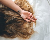 Woman with Brunette Hair Lying Down on the Bed