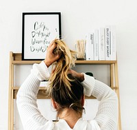 Rear View of a Woman Tying Her Hair Up 