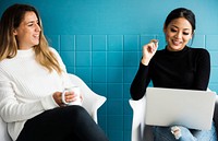 Two Female Friends are Having a Conversation While Having Coffee