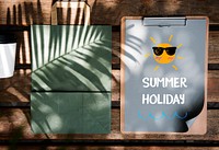 Summer poster on a paper clipboard