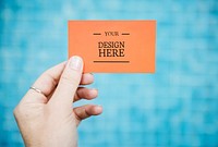 Hand holding a business card mockup
