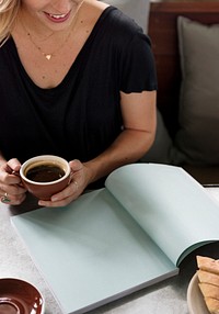 Woman having a coffee while reading a magazine