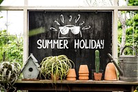 Summer themed blackboard in a greenhouse