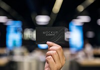 Hand holding a black business card mockup