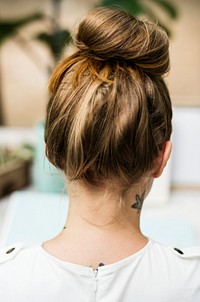 Rear view of woman with tattoo at her neck