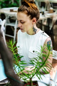 Woman with a bun reading at a cafe