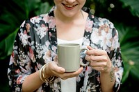 Happy woman holding a mug cup