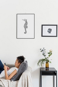 Decorated wall and a woman resting on the couch