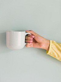 Closeup of hand holding coffee cup