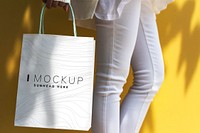 Woman holding a shopping bag mockup