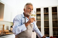 A man drinking a glass of wine