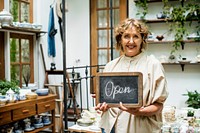 A woman owner with open sign