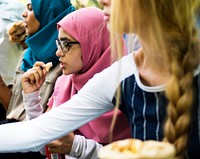 A group of diverse students are having lunch together