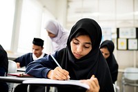 diverse muslim children studying in classroom