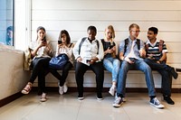 Group of diverse students using mobile phones