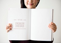An Asian woman is holding a blank magazine