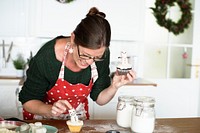 Woman decorating cupcakes for Christmas