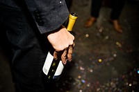 Closeup of hand holding champagne bottle