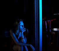 Woman sitting alone in the dark