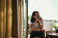Man sitting and smoking at a balcony