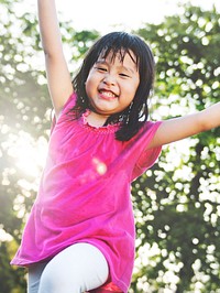 Little Asian girl playing in the park