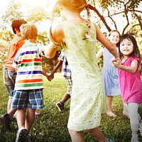 Cute diverse kids dancing in the park