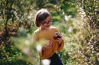 Little girl picking holding some apples