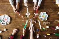 Kids&#39; hands holding Christmas character decorated popsicle sticks