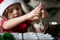 Little girl making chocolate cupcakes