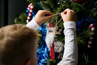 Boy decorating a Christmas tree