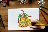 A person drawing Christmas bells