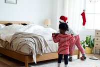 Little kids playing in a bedroom