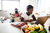 Black girl using laptop at home