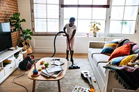 Young teen girl vacuuming up the house