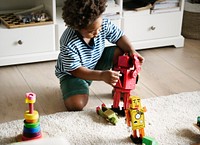 Black boy playing robot at home