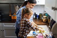 Daughter helping mom in cleaning dishes