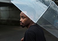 African descent man in an umbrella