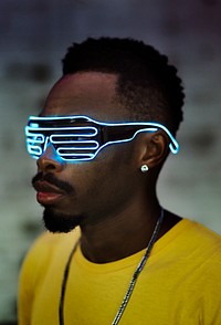 Young man wearing futuristic led glasses