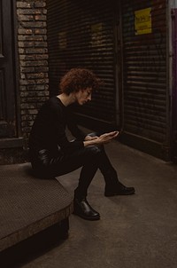 Woman waiting with mobile phone in hand