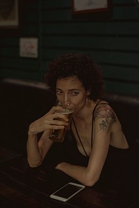 Lone woman having a beer at a bar