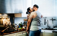 Wife kissing husband at the kitchen