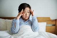 A woman waking up with headache